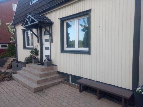 a house with stairs and a window and a bench at Villa Kungssten in Gothenburg