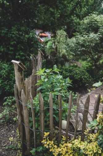 a wooden fence in a garden with flowers at Ferienwohnung Traudl in Inzell