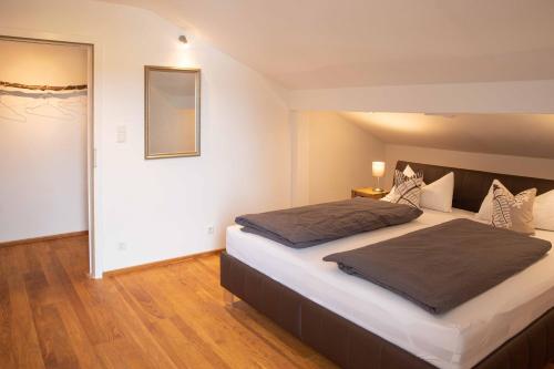 a bedroom with a large bed and a mirror at Ferienwohnung Traudl in Inzell