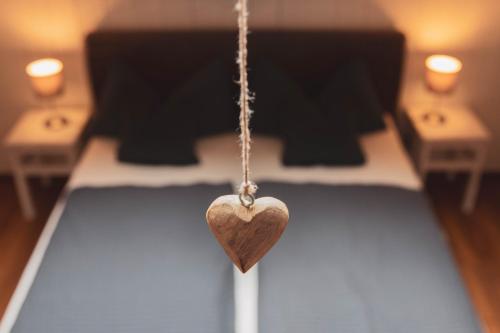 a wooden heart hanging on a chain in a room at Ferienwohnung Traudl in Inzell