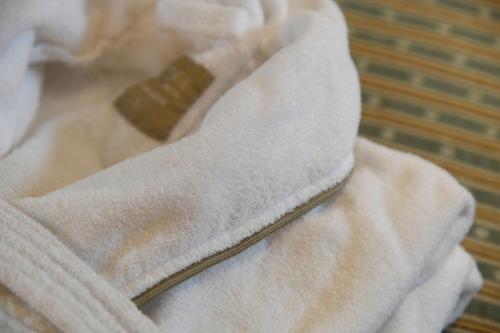 a white towel sitting on top of a bed at The Bell at Ramsbury in Marlborough