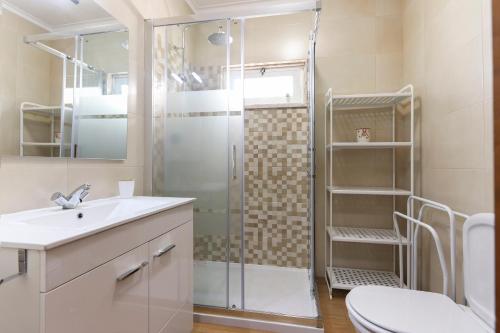 a bathroom with a shower and a toilet and a sink at Charming Guesthouse - Sónias Houses in Lisbon