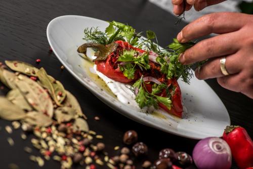 a person is eating a salad on a plate at Gillham Vineyard Hotel in Temblos