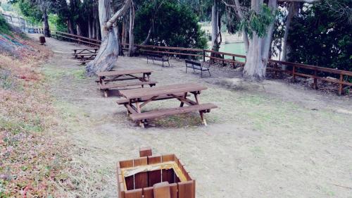 a row of wooden benches in a park at Hotel Chancelas in Chancelas