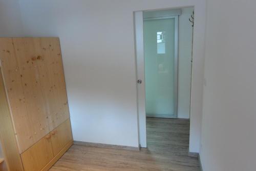 an empty room with a closet and a door at Haus Erli in Mittenwald