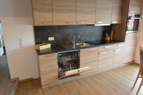a kitchen with a sink and a dishwasher at Haus Erli in Mittenwald