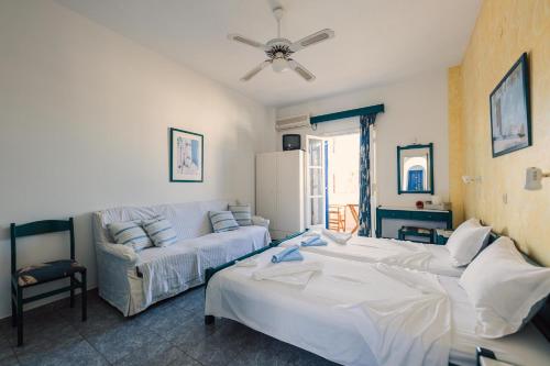 a living room with two beds and a couch at Villa Anna Maria in Aliki