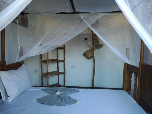 Postel nebo postele na pokoji v ubytování Furaha Lodge