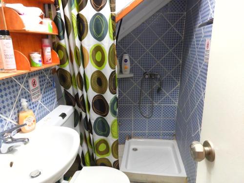 a bathroom with a toilet and a sink and a shower at Sailor's small studio in Corfu