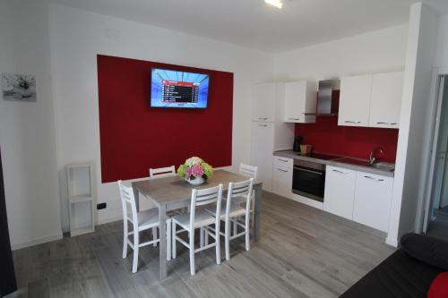 a kitchen and dining room with a table and chairs at Villa Lori Apartments Garden and Beach in Peschiera del Garda