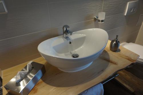 a bathroom with a white sink on a wooden counter at Ferienhaus Hundertmorgenfeld 33 in Wernigerode