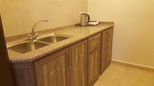 a kitchen counter with a sink and a coffee maker on it at Sultan Home in Wadi Musa