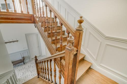a wooden staircase in a home with white walls at Maison Qui s'y frotte s'y pique in Robert-Espagne