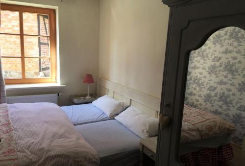 a bedroom with two beds and a window at Pfarrhof Stuer in Stuer