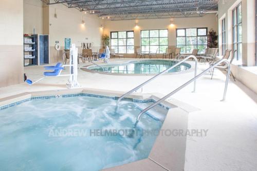 a large indoor swimming pool in a building at Baymont by Wyndham Battle Creek/I-94 in Battle Creek