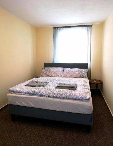 a bed in a room with a large window at Kamus in Baden-Baden
