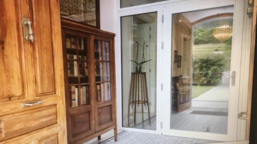 an entrance to a house with a glass door at Villa Marta Casa de Indianos Passive House in Villanueva de Ardisana