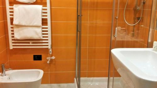 a bathroom with a shower and a sink and a sink at Blue Shades Hotel in Pisa