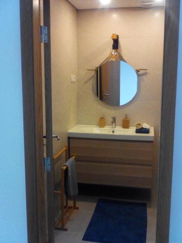 a bathroom with a sink and a mirror at Home Sleep Home Fafe in Fafe