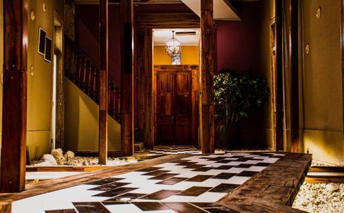 a hallway with a checkered floor in a building at Hotel Boutique Suri in La Serena