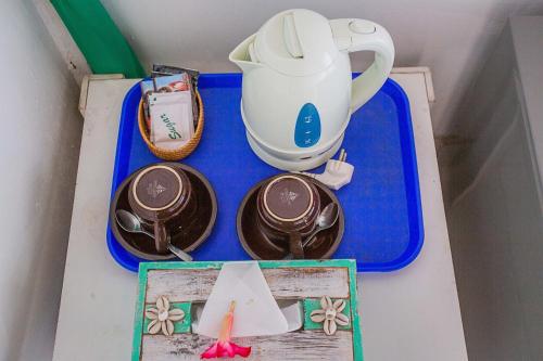 a blue tray with plates and a tea pot on it at Svaha Private Villas Ceningan in Nusa Lembongan