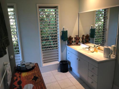 a bathroom with a sink and a mirror at Mission Beach Escape BnB in South Mission Beach