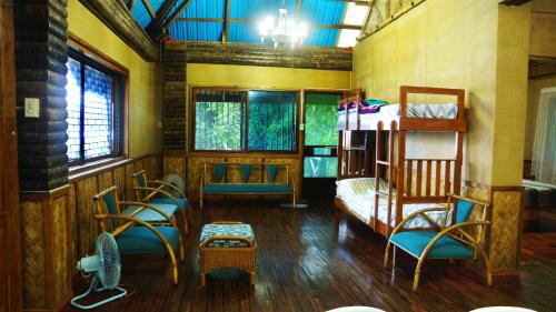 a room with a bunk bed and chairs in it at Villa Serena in Santo Domingo