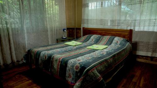 a bedroom with a bed with green towels on it at Villa Serena in Santo Domingo