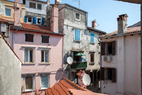 a group of buildings and roofs in a city at Villa Nea Seaview 3-apartments! in Rovinj