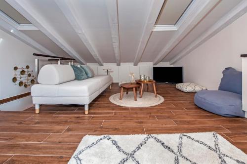 a living room with a couch and a table at Villa Nea Seaview 3-apartments! in Rovinj