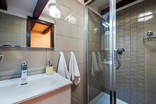 a bathroom with a sink and a shower at Villa Nea Seaview 3-apartments! in Rovinj