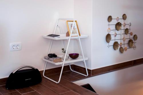 a white shelf in a room with a black bag at Villa Nea Seaview 3-apartments! in Rovinj
