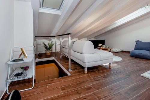 a living room with a white chair and a couch at Villa Nea Seaview 3-apartments! in Rovinj