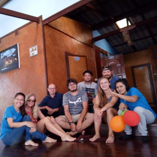 a group of people posing for a picture in a room at TA YAI HOMESTAY (ตา ยาย โฮมสเตย์) in Ko Kood