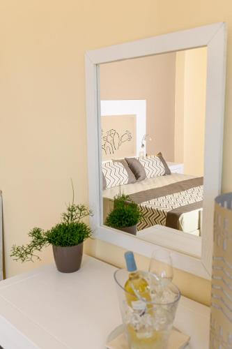a mirror on a counter with a bed in a bedroom at Hotel Lido Beach PHG in Oristano