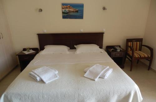 a bedroom with a bed with two towels on it at Irides in Souvala