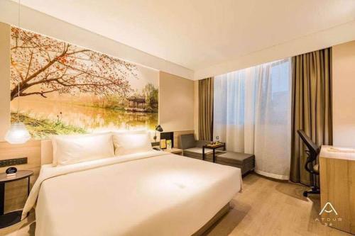 a hotel room with a bed and a large window at Atour Hotel Yangzhou Ancient Canal Dongguan Street in Yangzhou