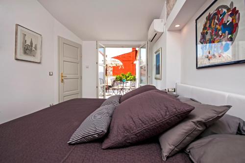a bedroom with a bed with pillows on it at Seaview House Rosali in Rovinj