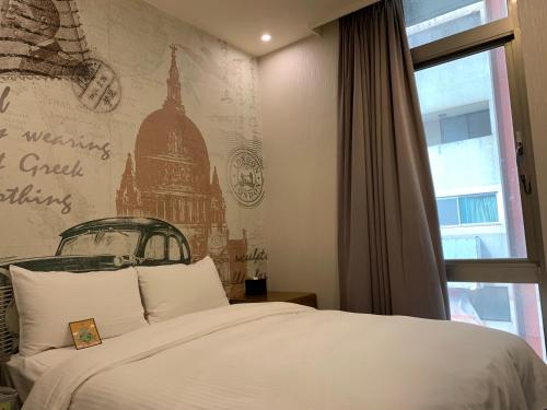 a bedroom with a bed and a wall with a mural at Skyone Hotel in Kaohsiung