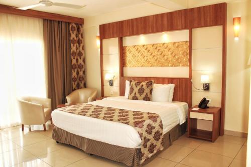 a hotel room with a bed and a telephone at Atlantic Hotel in Djibouti
