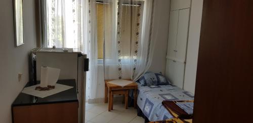 a small room with a bed and a window at Apartments Draga in Budva