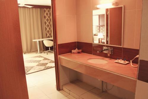 a bathroom with a sink and a mirror at Atlantic Hotel in Djibouti