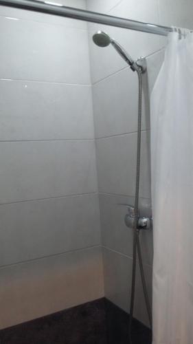 a shower with a shower curtain in a bathroom at Joniskera in Tbilisi City