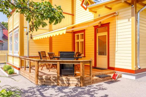 a wooden deck with a table and chairs on a house at Villa Rosalie in Pärnu