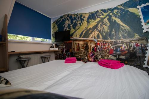 a bedroom with a large bed with a mountain mural on the wall at B&B Aangenaam - Olde Horst Diever in Diever