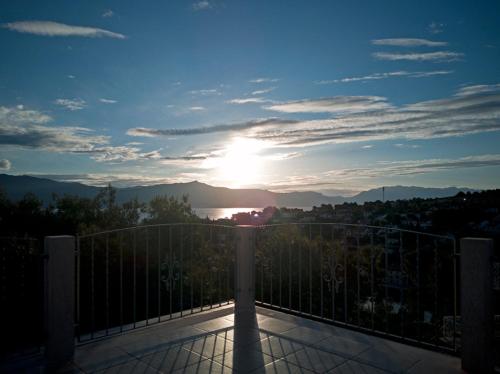 a view of the sun setting from a balcony at Villa Ujoli in Splitska