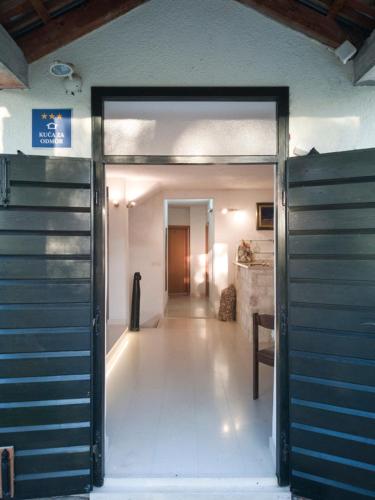 a hallway with a door open to a room at Villa Ujoli in Splitska