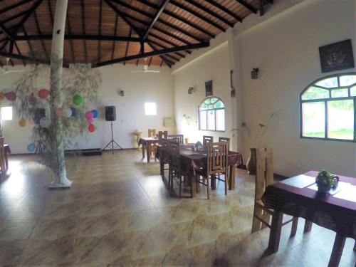 a dining room with tables and chairs and a stage at Dhammika Magic Palace in Wadduwa
