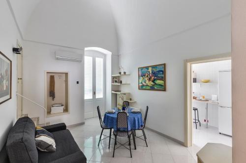 a living room with a table and a couch at Il Cedrangolo House in Monopoli