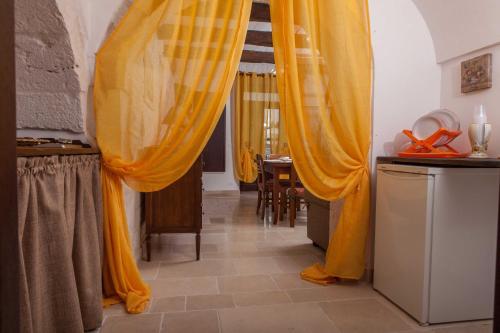 a living room with yellow curtains and a table at Da Santino in Alberobello